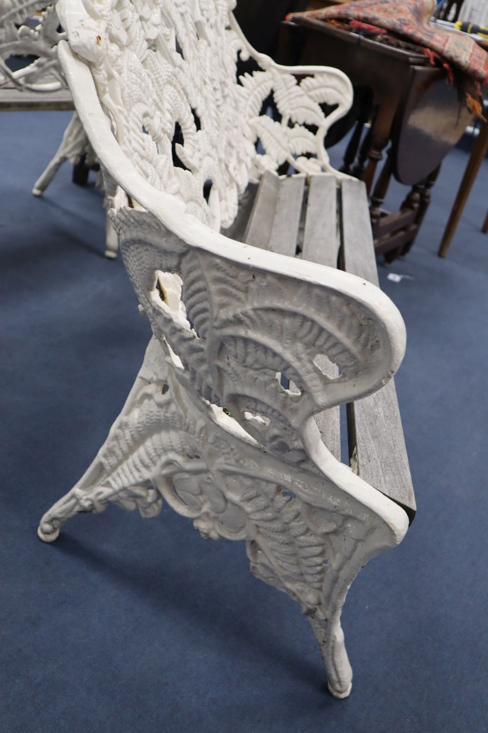 A pair of Coalbrookdale style cast iron garden benches, in fern pattern, with teak slats, width 151cm, depth 26cm